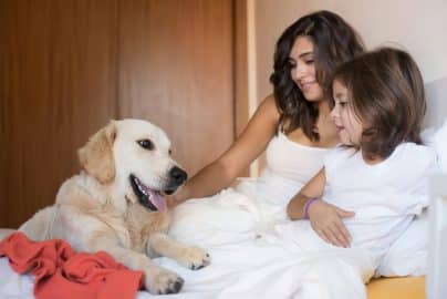 Family with dog in the bed