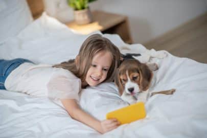 Female child taking selfies with her dog